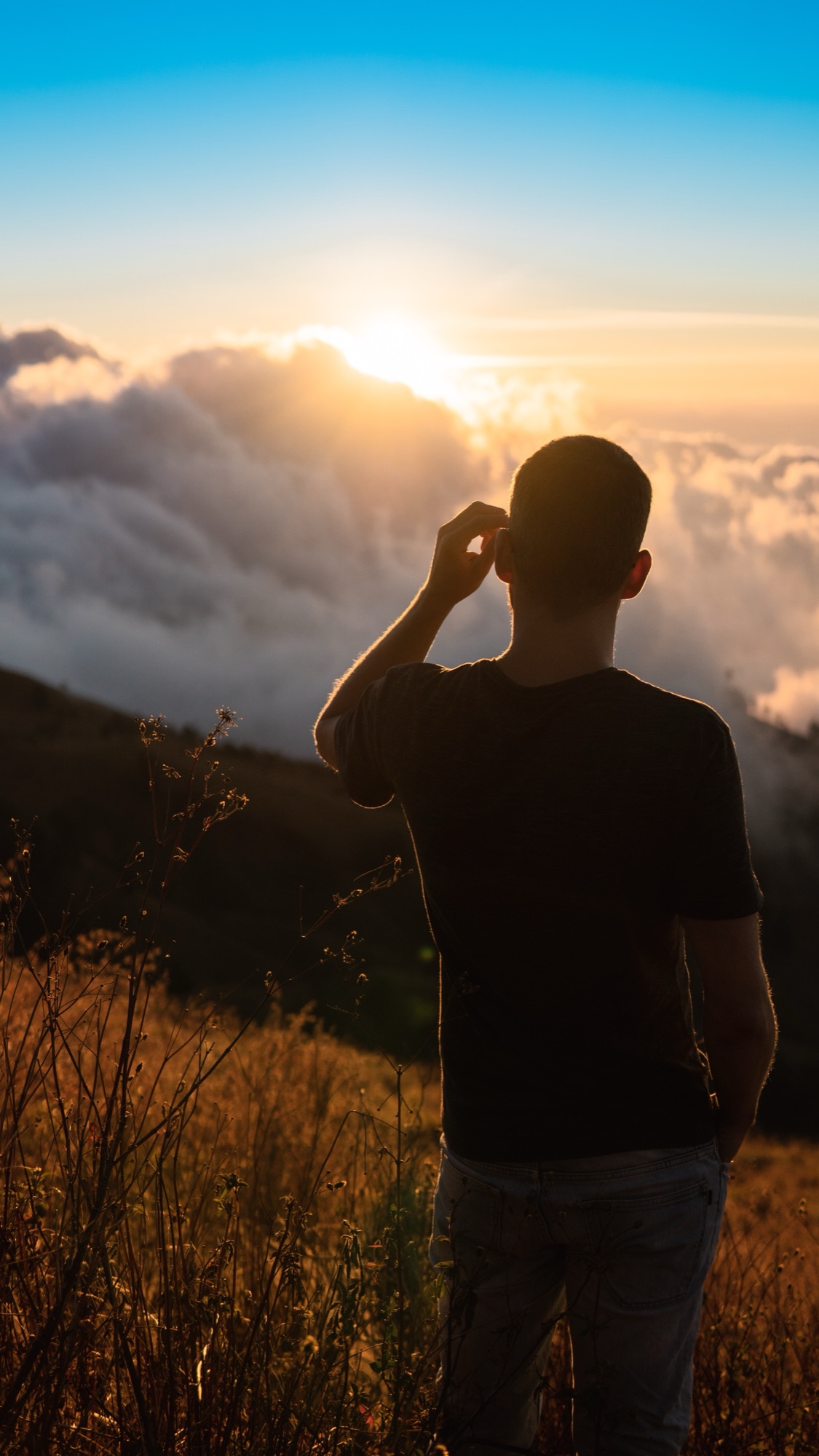 Silhouette watching the sunrise above the clouds, Indonesia